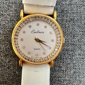 Eastman women's quartz wristwatch gold-tone case, white dial crystals